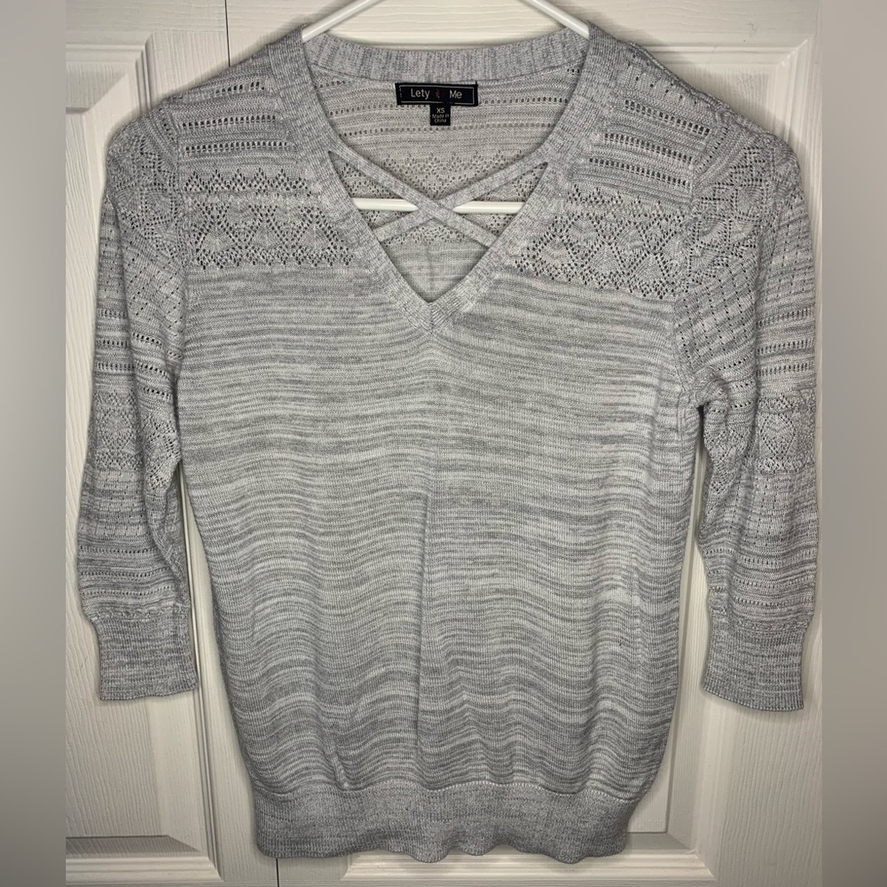 Women’s v-neck with criss cross design, 3/4 sleeve, xs.